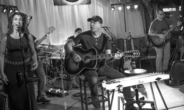 Black and white colored picture of members in our Pink Floyd tribute show performing at private event | Altus Entertainment